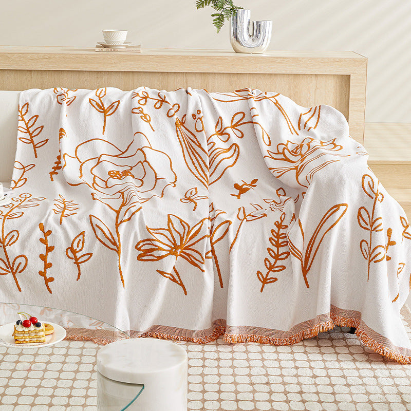 White sofa throw with orange flower patterns